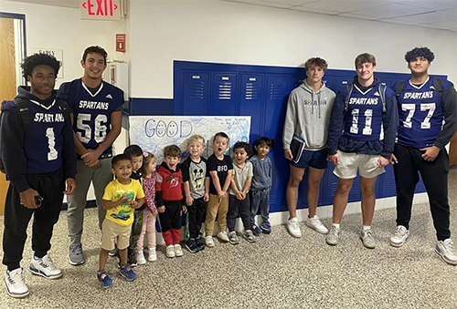 PHS football players visiting preschool students