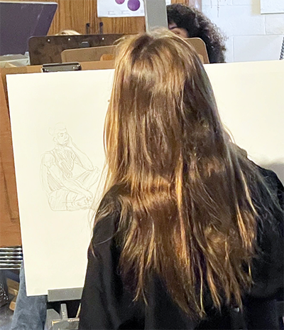 Art student drawing in figure drawing class