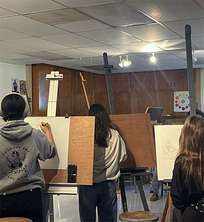 View of art student drawing in art class